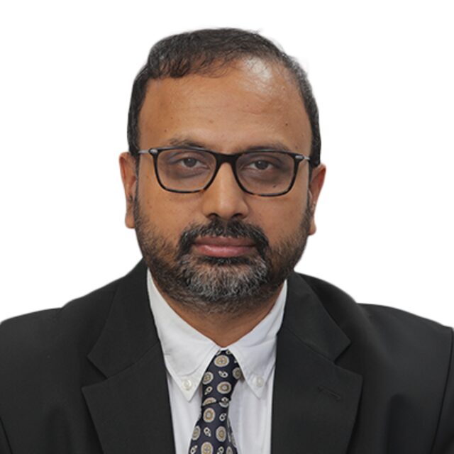 Portrait of Kaushik Mitra, faculty at First Bridge Business School