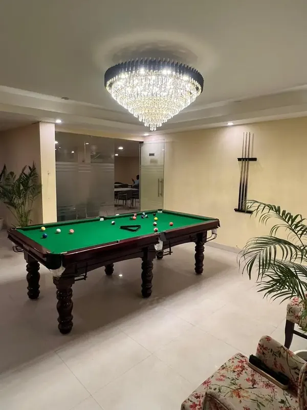 The games room with a pool table in a First Bridge student home