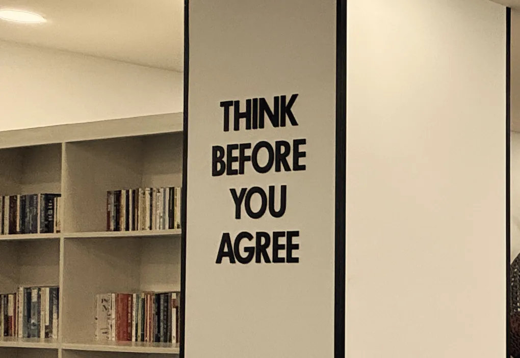 The library pillar at First Bridge that reads 'Think before you agree'